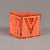 Color tinted acrylic cube with orange pigment featuring four sides laser engravings.